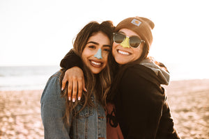 Two woman wearing NÖZ reef safe sunscreen spf 30-50 collection 